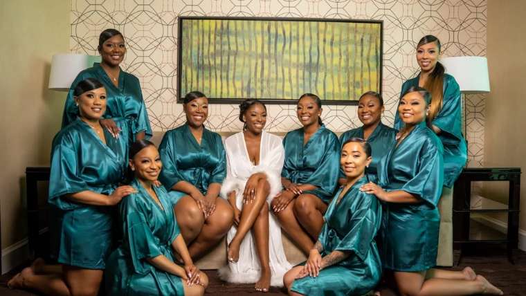 Party in matching teal robes posed together in a hotel suite, Las Vegas bachelorette photography