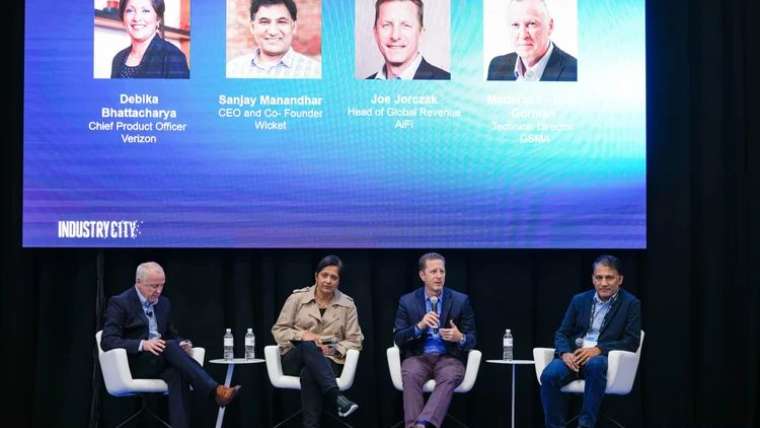Panel of speakers on stage at a Las Vegas conference, corporate event photography coverage