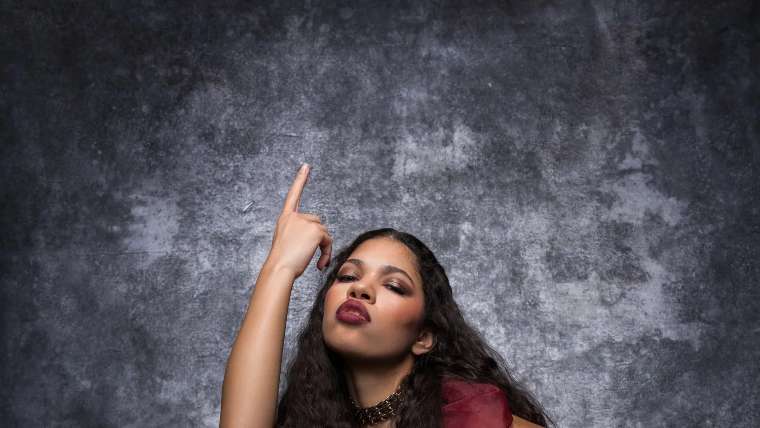 Editorial portrait in a burgundy gown with arm raised in studio, Las Vegas portrait photography